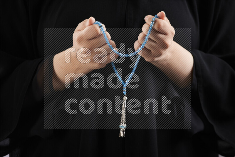 Woman hands holding praying beads (sebha) in different positions