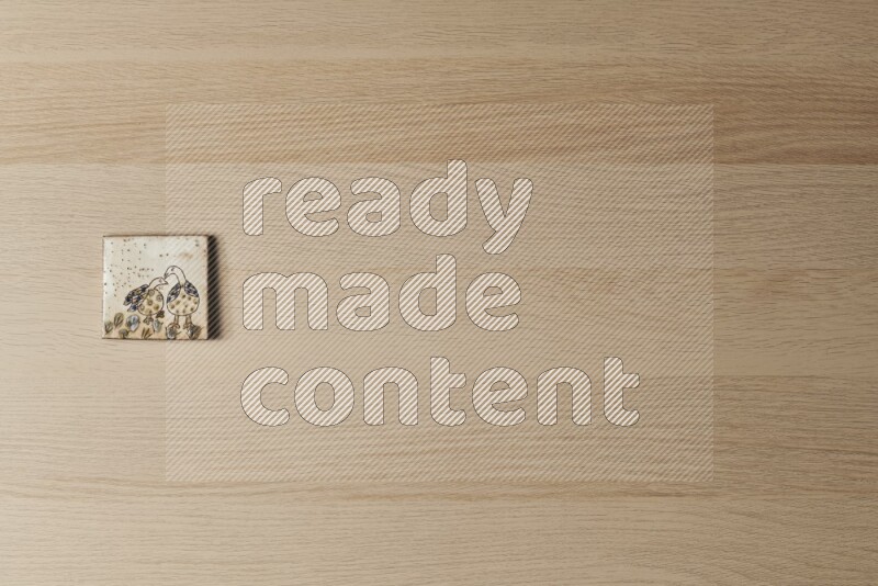 A decorative pottery coaster on light wooden background