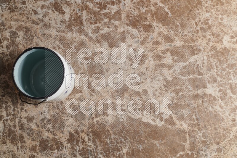 A vintage milk can on beige marble background