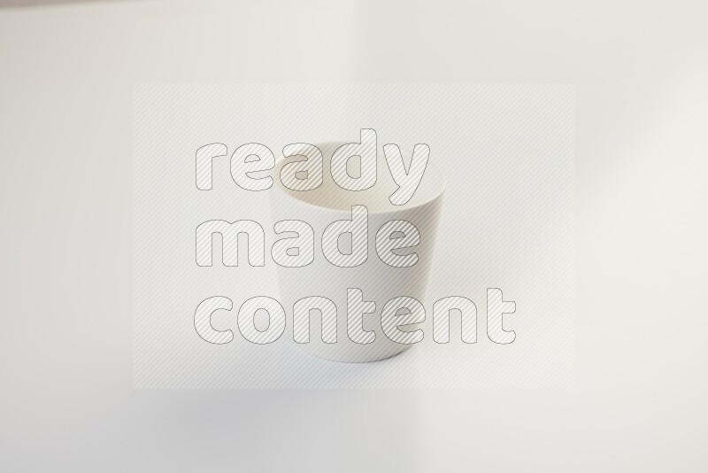 white ceramic cup on white countertop