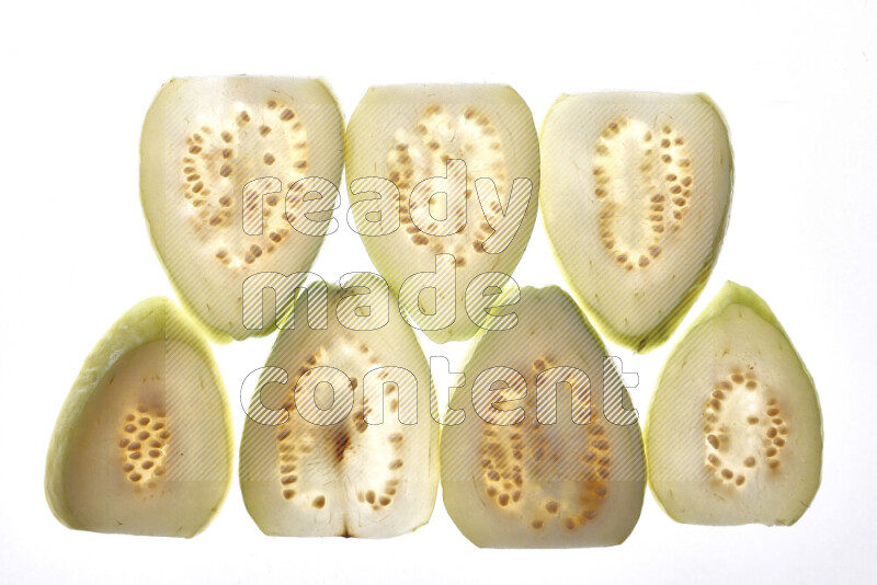 Guava slices on illuminated white background
