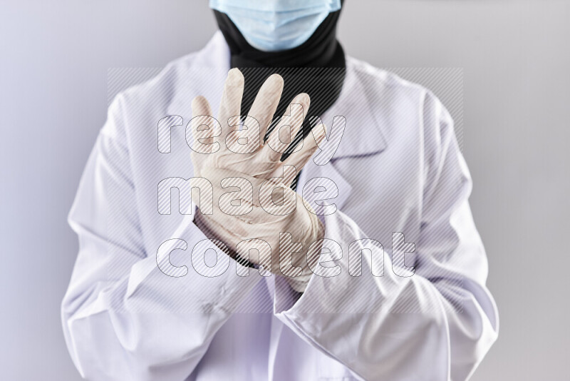 Female doctor wearing an abaya and medical attire in different positions