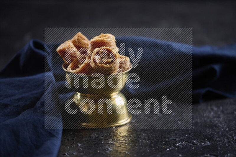 konafa in a metal bowl in a dark setup