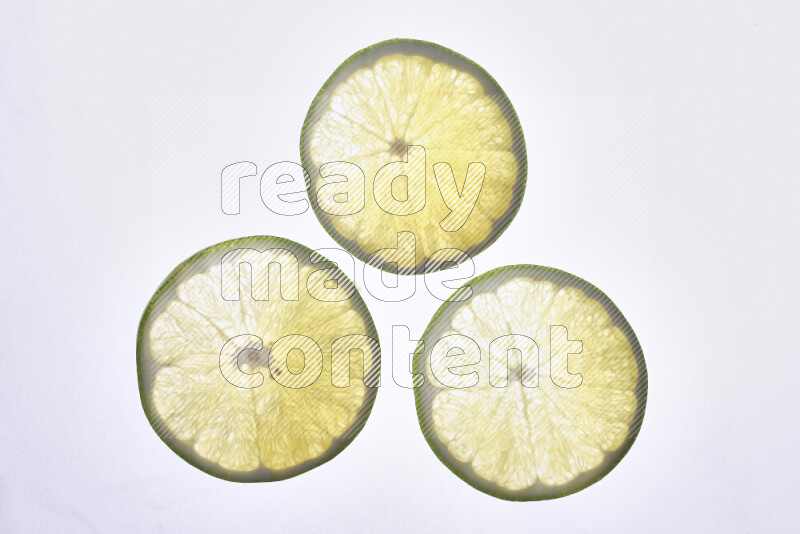 Orange slices on illuminated white background