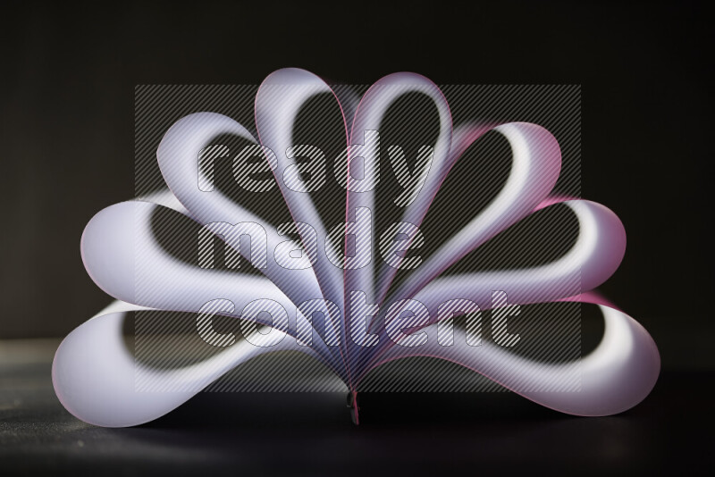 An abstract art piece displaying smooth curves in pink and white gradients created by colored light