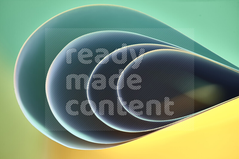 An abstract art of paper folded into smooth curves in green and yellow gradients