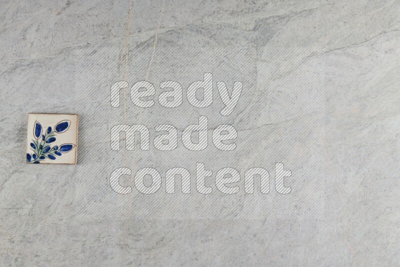 A decorative pottery coaster on grey marble background