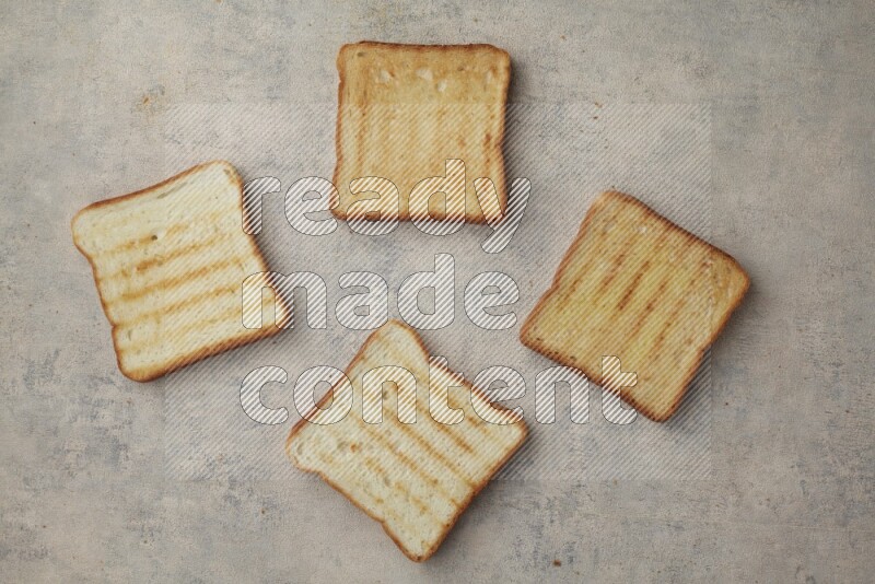 Toasted white Toast slices on a light blue textured background