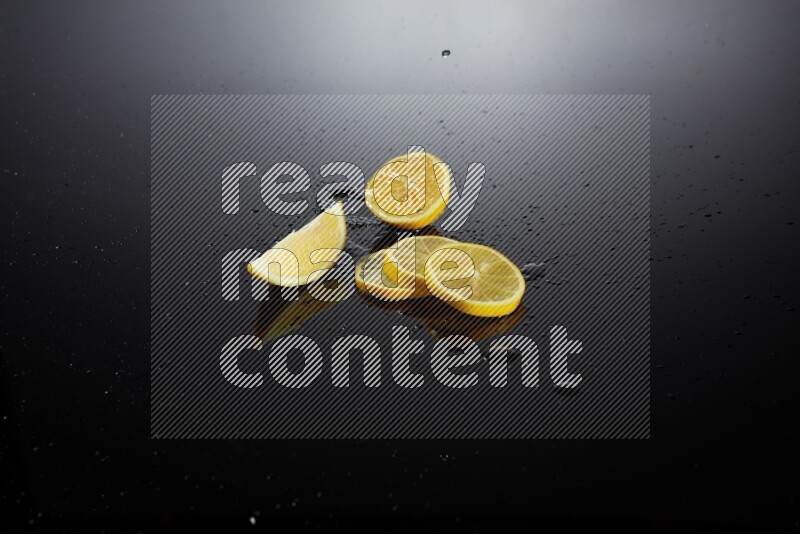 Lemon slices with water drops, and droplets on black background