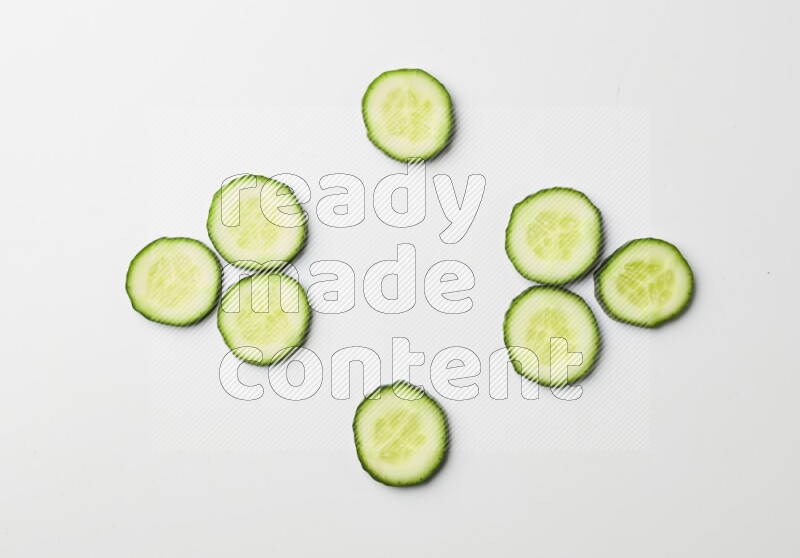 Multiple cucumber slices on white background