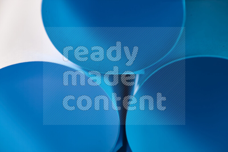 الصورة تعرض فن ورقي تجريدي بأشكال دائرية بدرجات متنوعة من اللون الأزرق