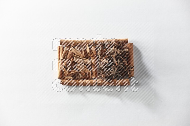 2 squares of cinnamon sticks full of star anise and cinnamon on white flooring