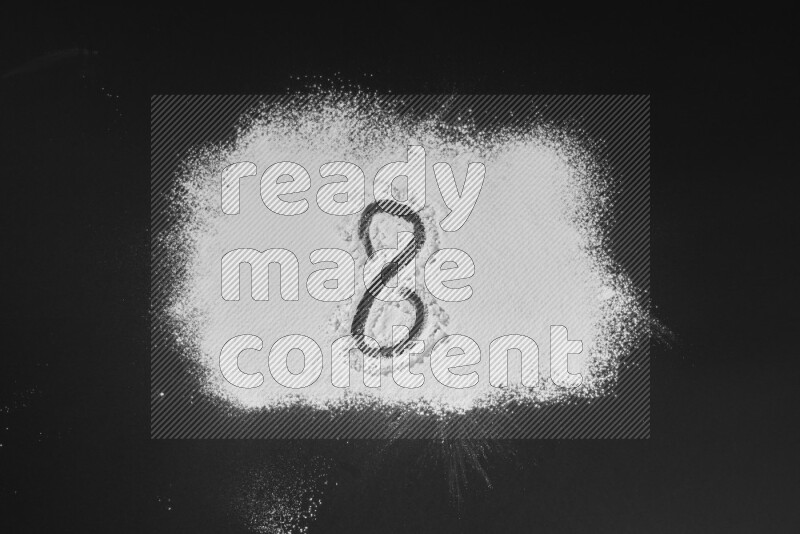 Numbers written with powder on black background