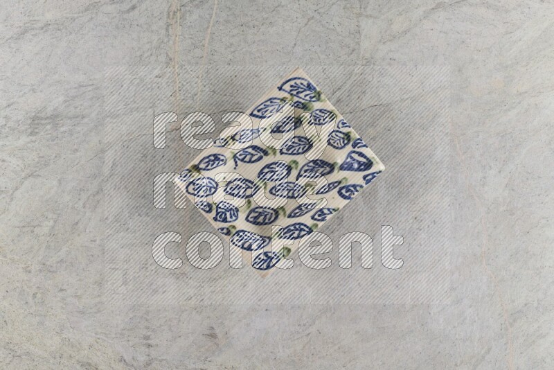A decorative pottery plate on grey marble background