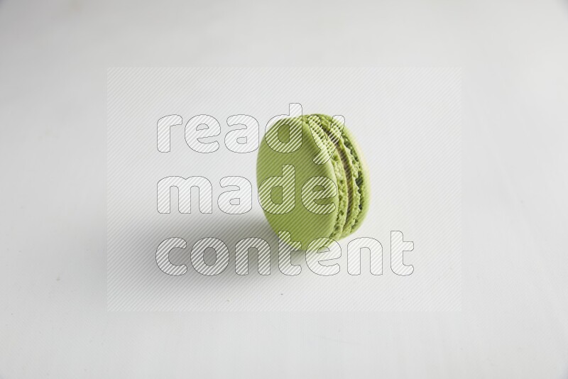 45º Shot of Green Pistachio macaron on white background