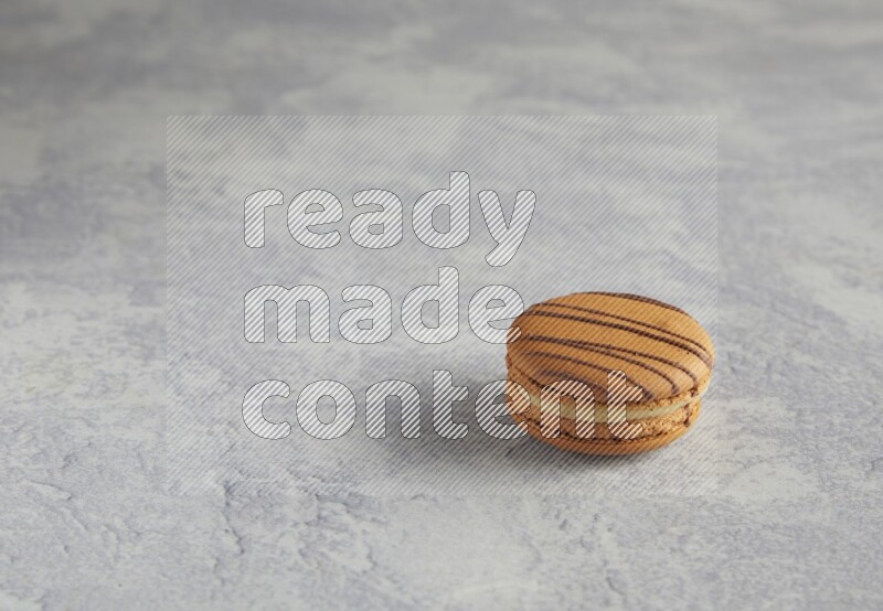 45º Shot of light brown  Almond Cream macaron on white  marble background