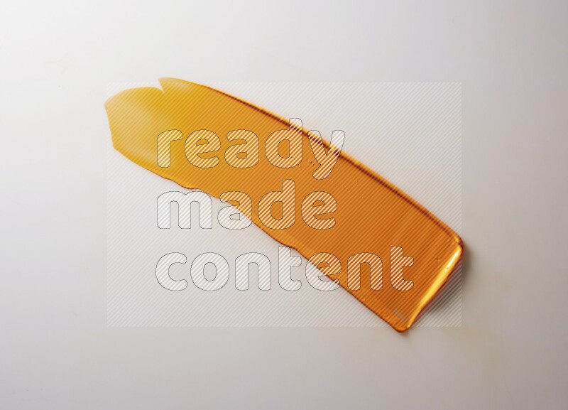 An orange straight painting knife stroke on white background
