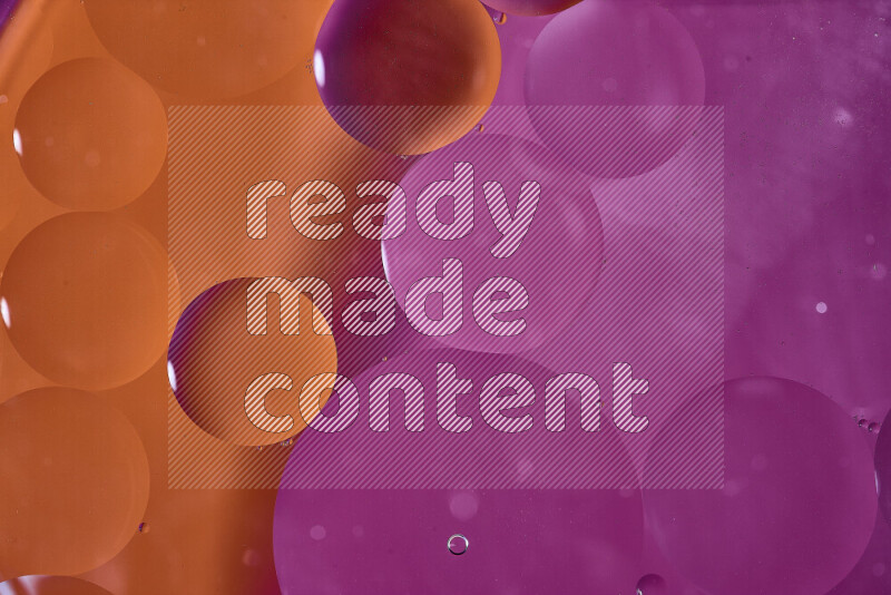 Close-ups of abstract oil bubbles on water surface in shades of orange and pink