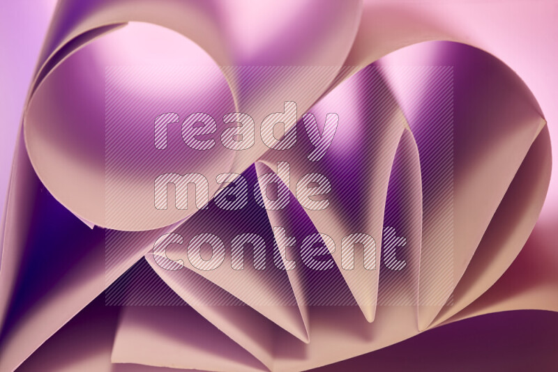 An artistic display of paper folds creating a harmonious blend of geometric shapes, highlighted by soft lighting in purple and warm tones