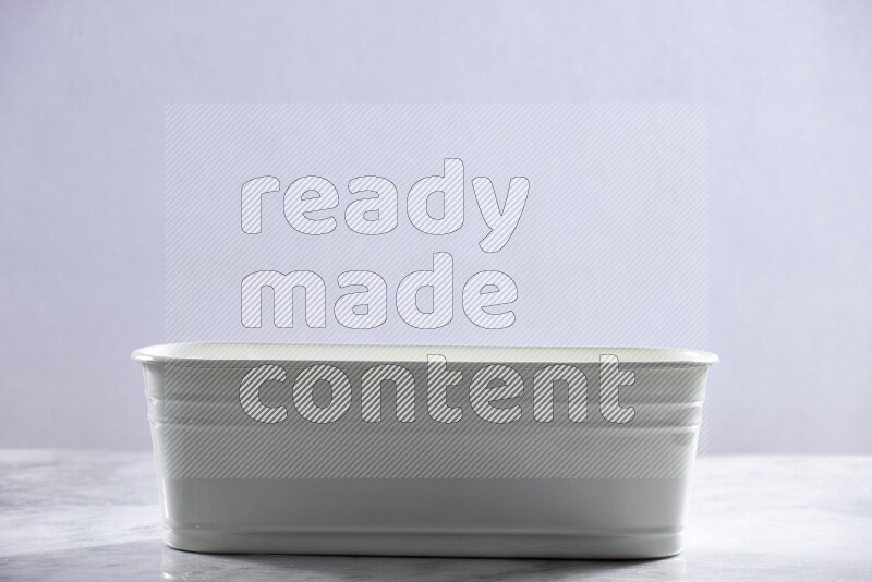 An empty white plant pot on grey marble background
