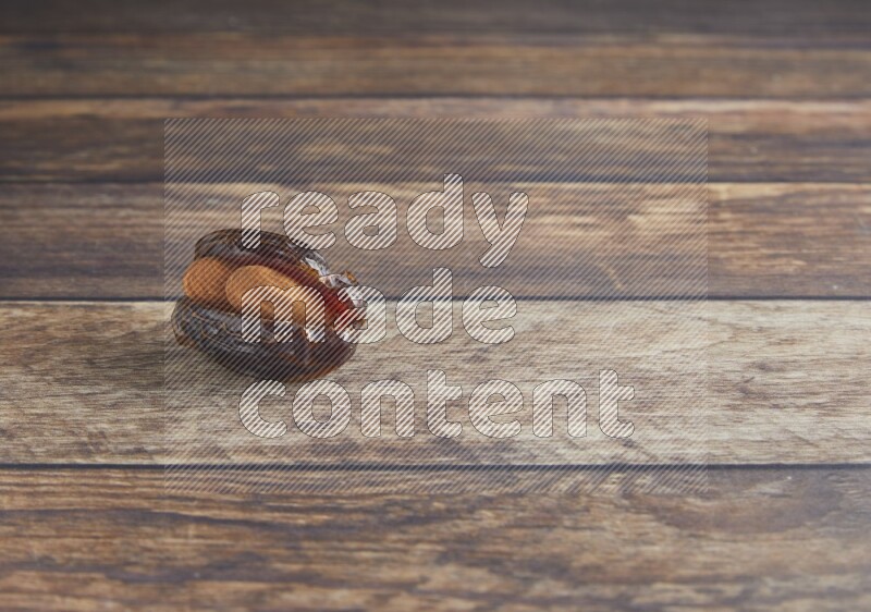 almond stuffed madjoul date on a wooden background
