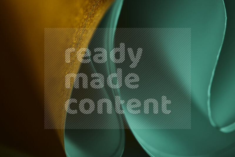 An abstract art piece displaying smooth curves in green and orange gradients created by colored light