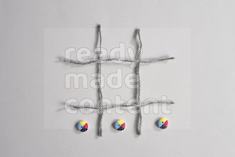 Multicolored buttons placed on grey background