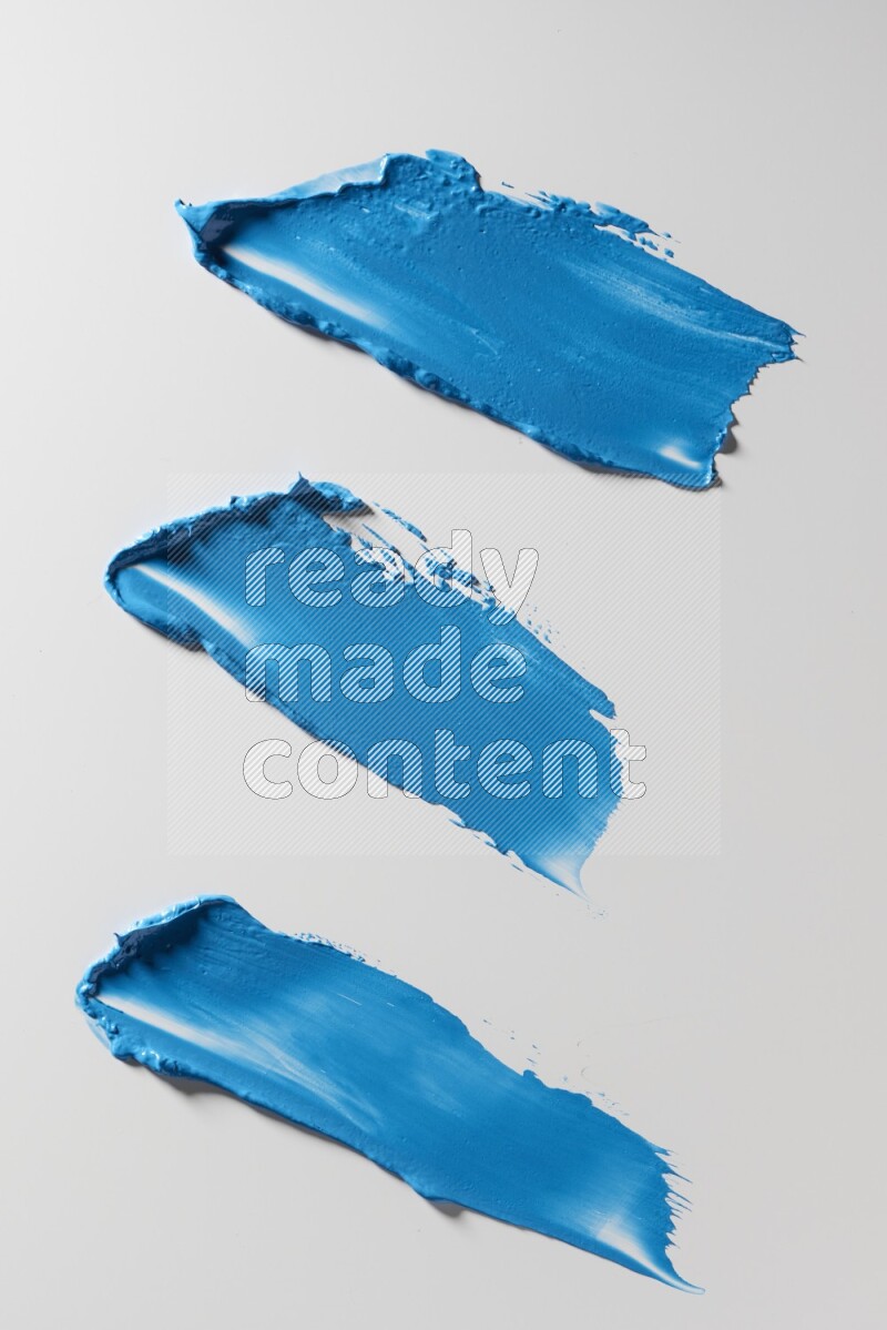 Blue painting knife strokes on a white background