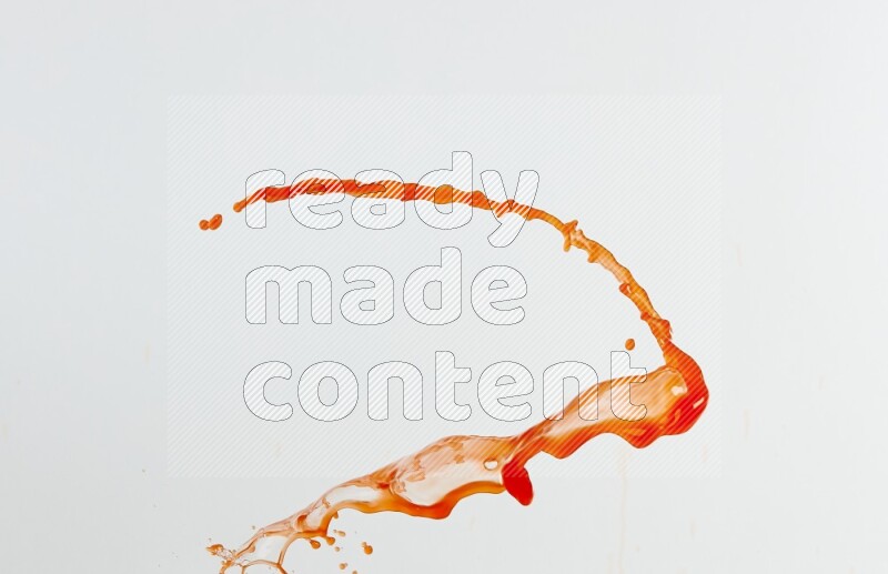 Orange liquid splash and drops on white background