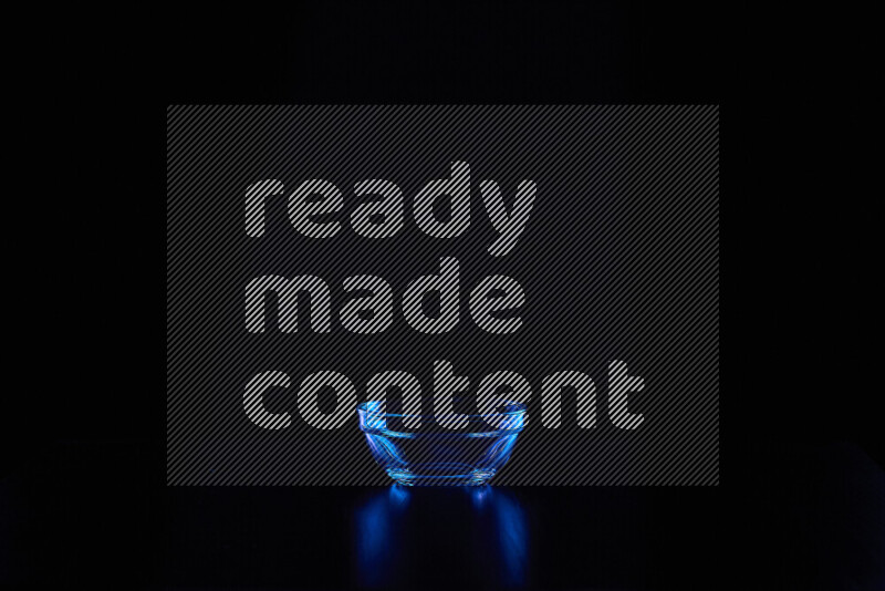 Glassware with rim light in blue against black background