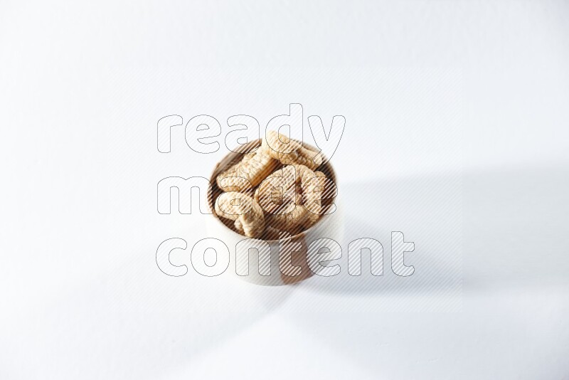 A beige ceramic bowl full of dried figs on a white background in different angles