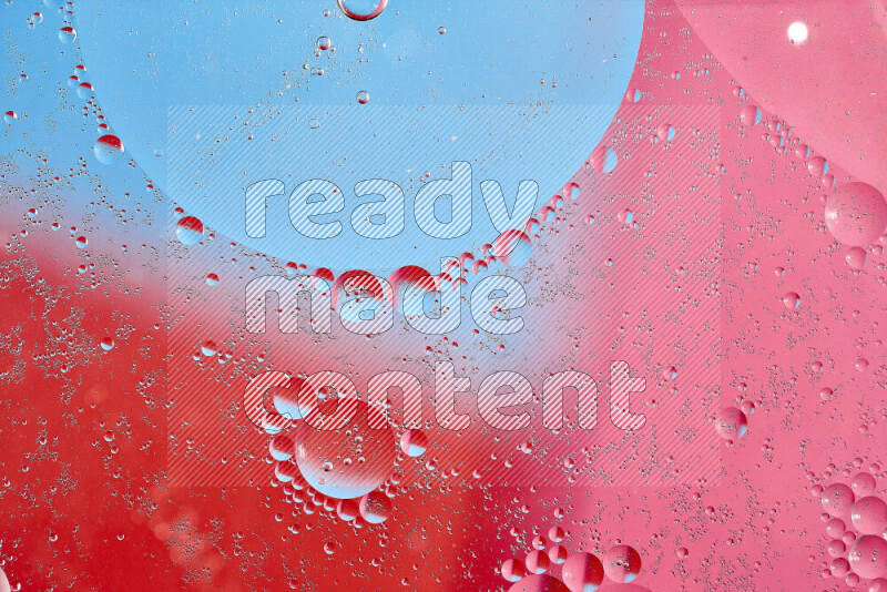 Close-ups of abstract oil bubbles on water surface in shades of blue, red and pink