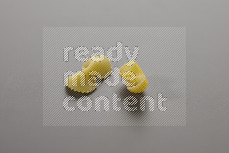 Fiocchi pasta with other types of pasta on grey background