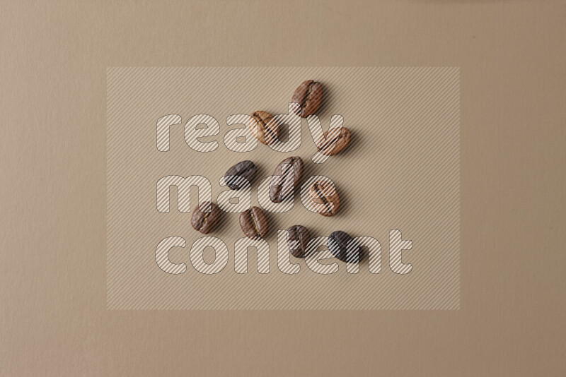 Roasted coffee beans on beige background
