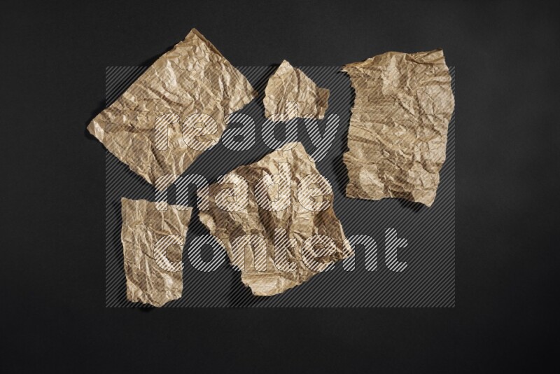Crumpled craft paper on black background