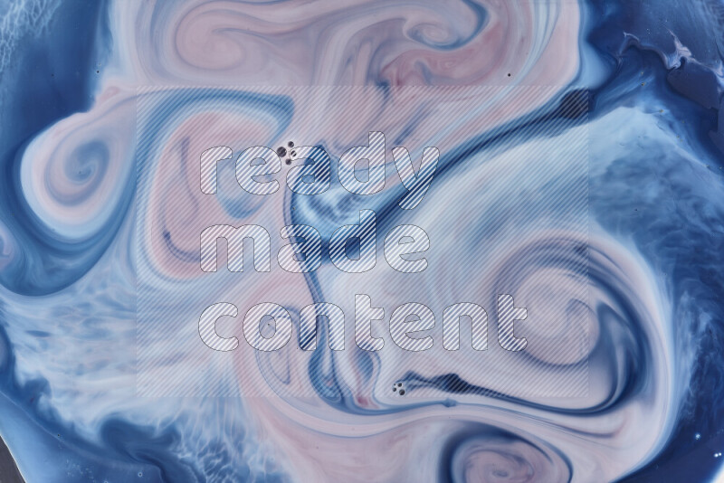A close-up of abstract swirling patterns in blue, red and white