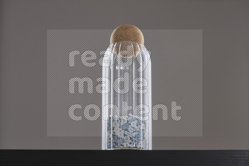 Buttons in a glass jar on black background