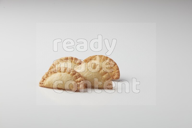 Four fried sambosas on a white background