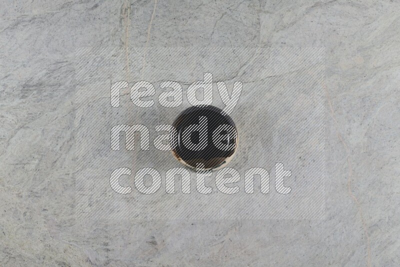 A multicolored pottery Bowl on grey marble background