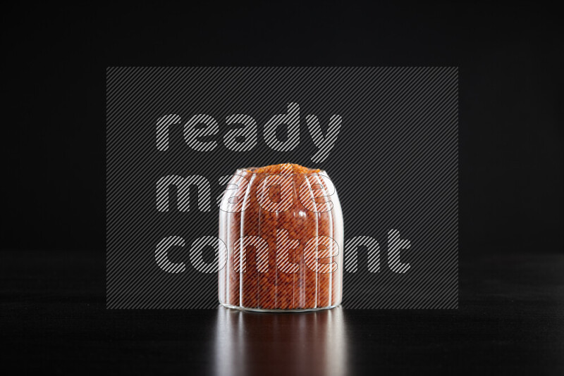 Lentils in a glass jar on black background