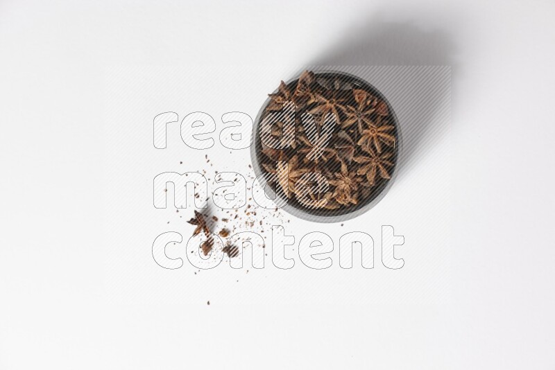 Star Anise in a wooden bowl on white flooring