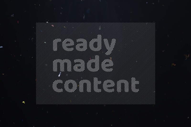 Falling multicolored confetti on black background