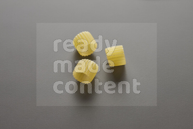 Big rings pasta on grey background