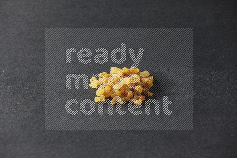Yellow raisins isolated on a black background in different angles