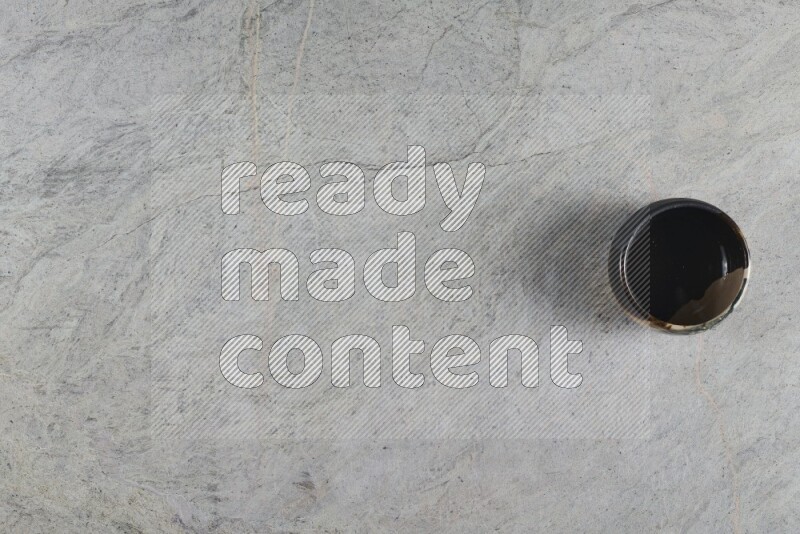 A multicolored pottery Bowl on grey marble background