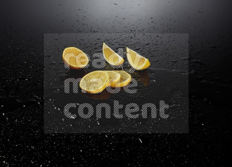 Lemon slices with water drops, and droplets on black background