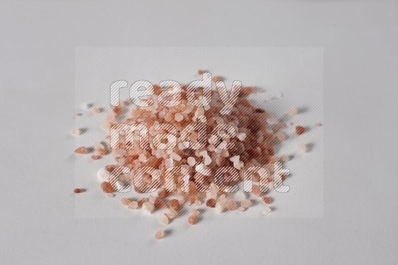 A bunch of coarse himalayan salt crystals on white background