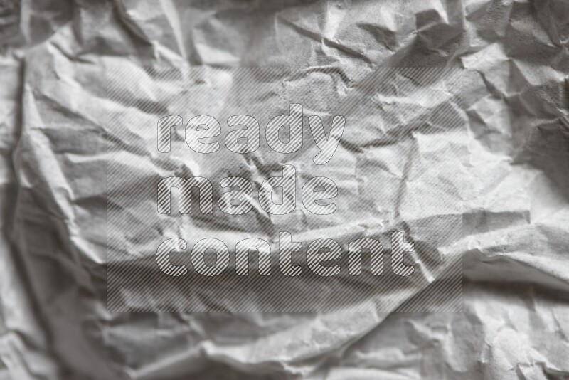 Crumpled notebook sheet on black background