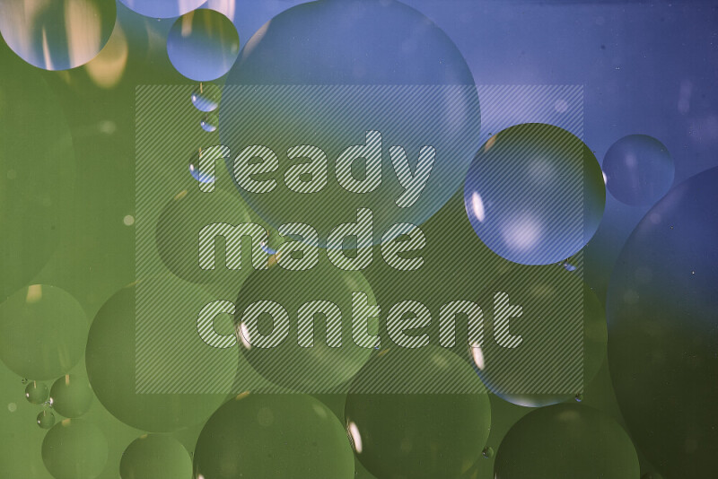 Close-ups of abstract oil bubbles on water surface in shades of blue and green