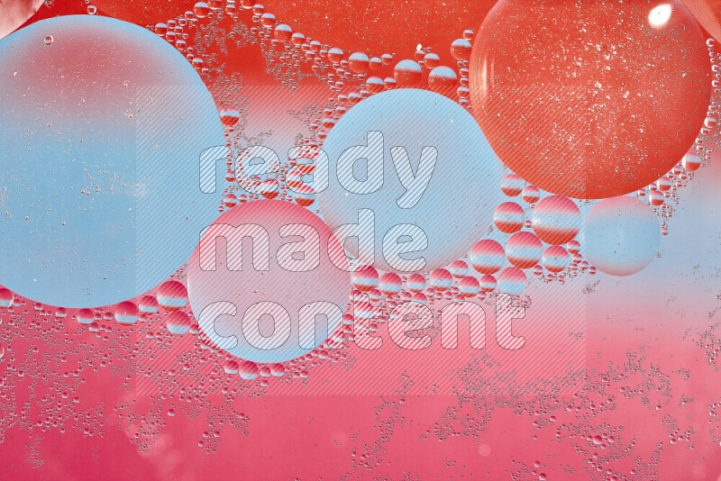 Close-ups of abstract oil bubbles on water surface in shades of blue, red and pink